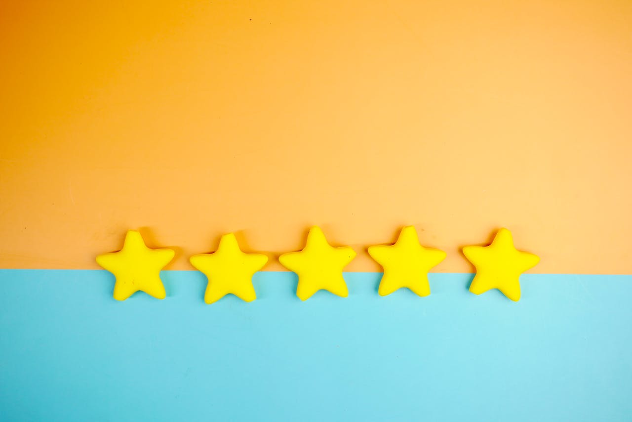 services-01 Bright yellow stars arranged on a vivid orange and blue background with copy space.
