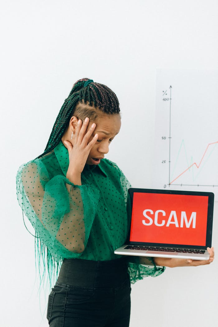 why-choose-us African American businesswoman shocked by scam alert on a laptop.